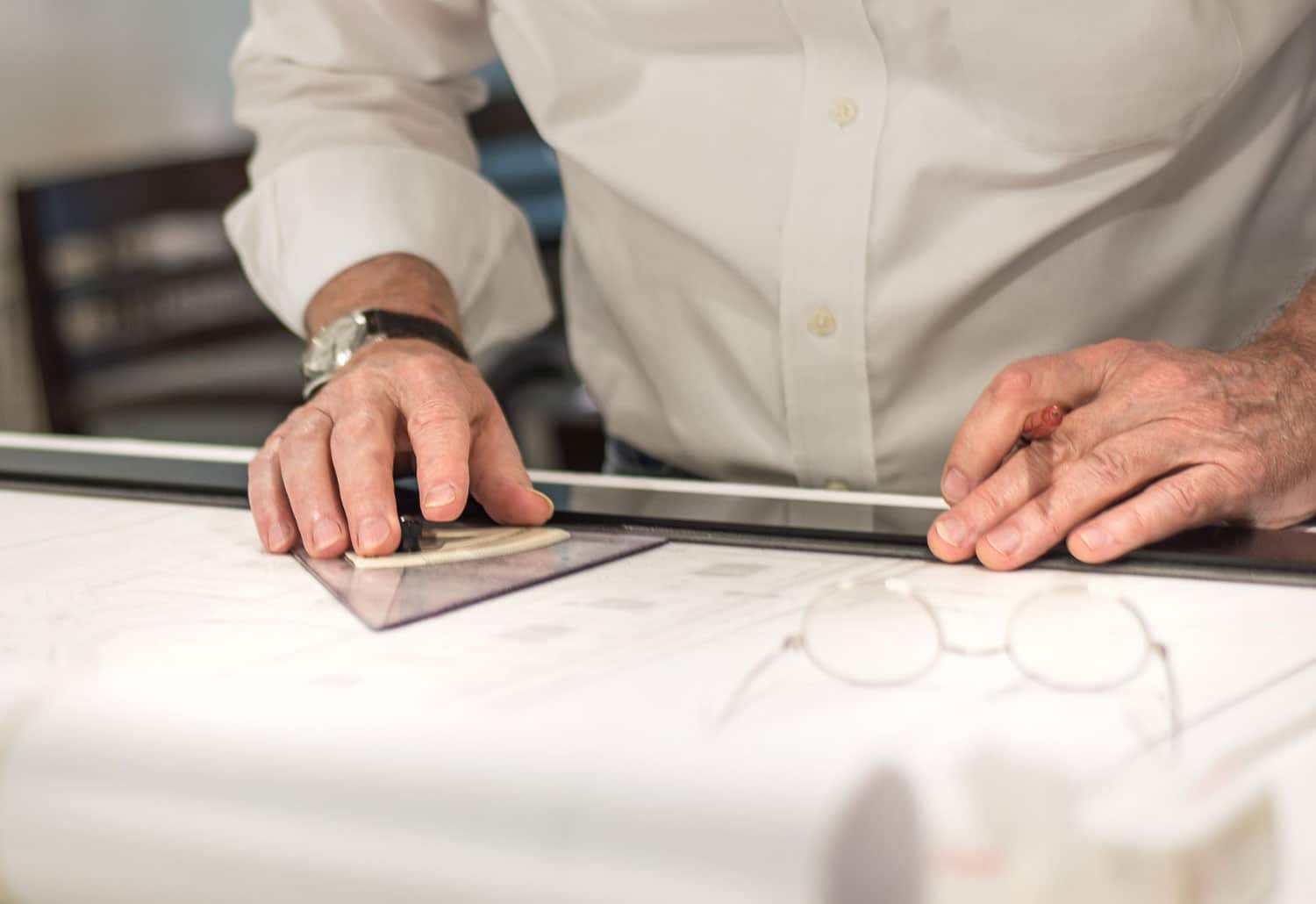 Close-up of hands inspecting blueprints